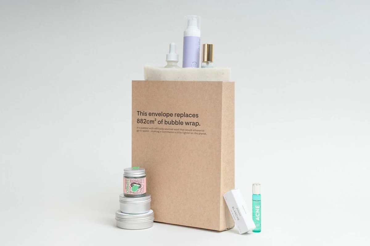 Different types of kraft paper packaging including brown mailer boxes white product boxes and kraft shopping bags