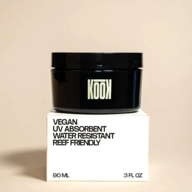 Black KOOK skincare jar with custom folding carton packaging