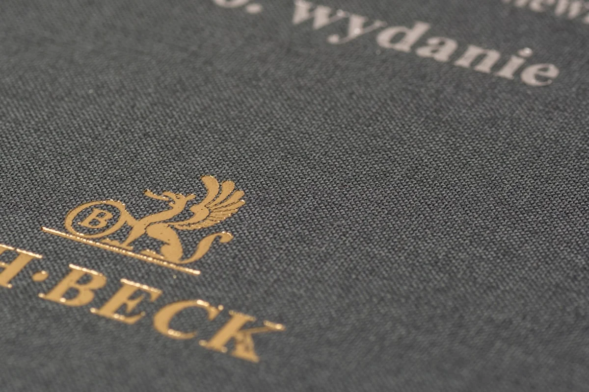 Close-up of gold foil stamped book cover showing embossed lettering and premium finishing