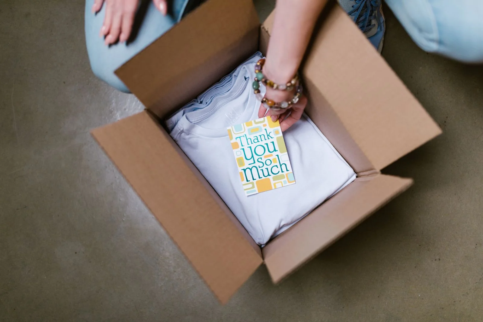 Thank you card placed inside ecommerce mailer packaging