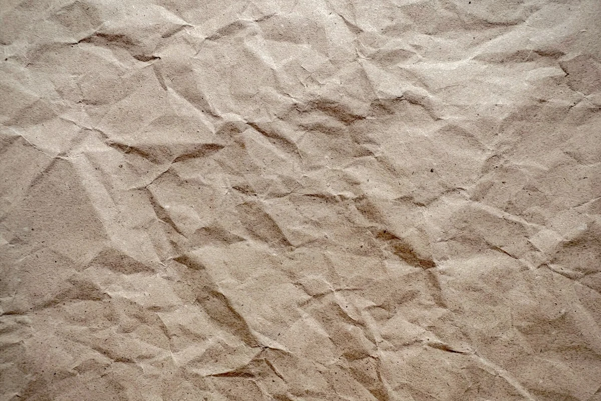 Crinkled brown kraft paper texture used as wrapping material for rigid boxes
