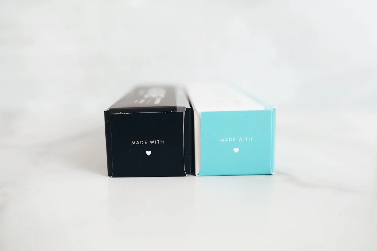 Black and red premium packaging boxes on a white table showing different box styles