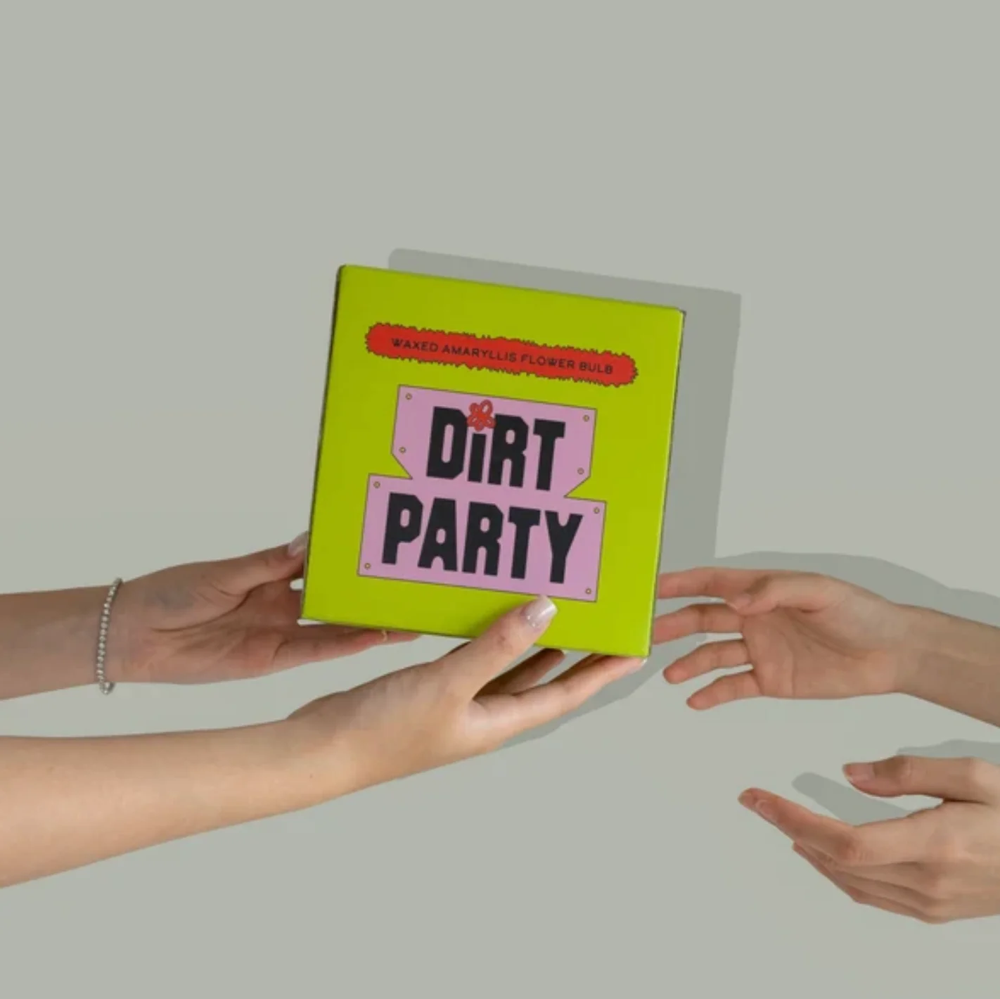Dirt Party gift box held out by hand