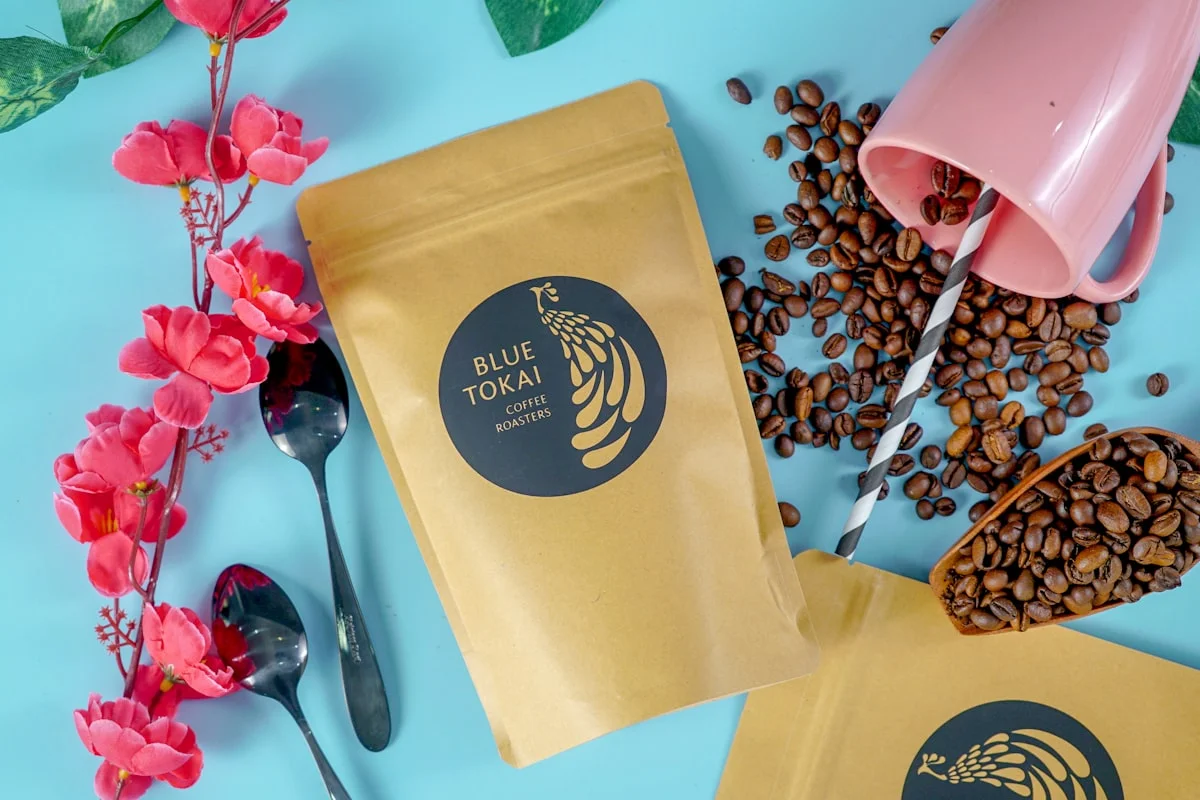 custom coffee pouches beside coffee cup for format planning