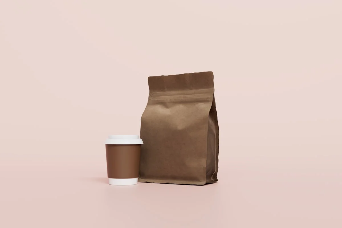 coffee pouch standing beside a cup for front panel dimension review