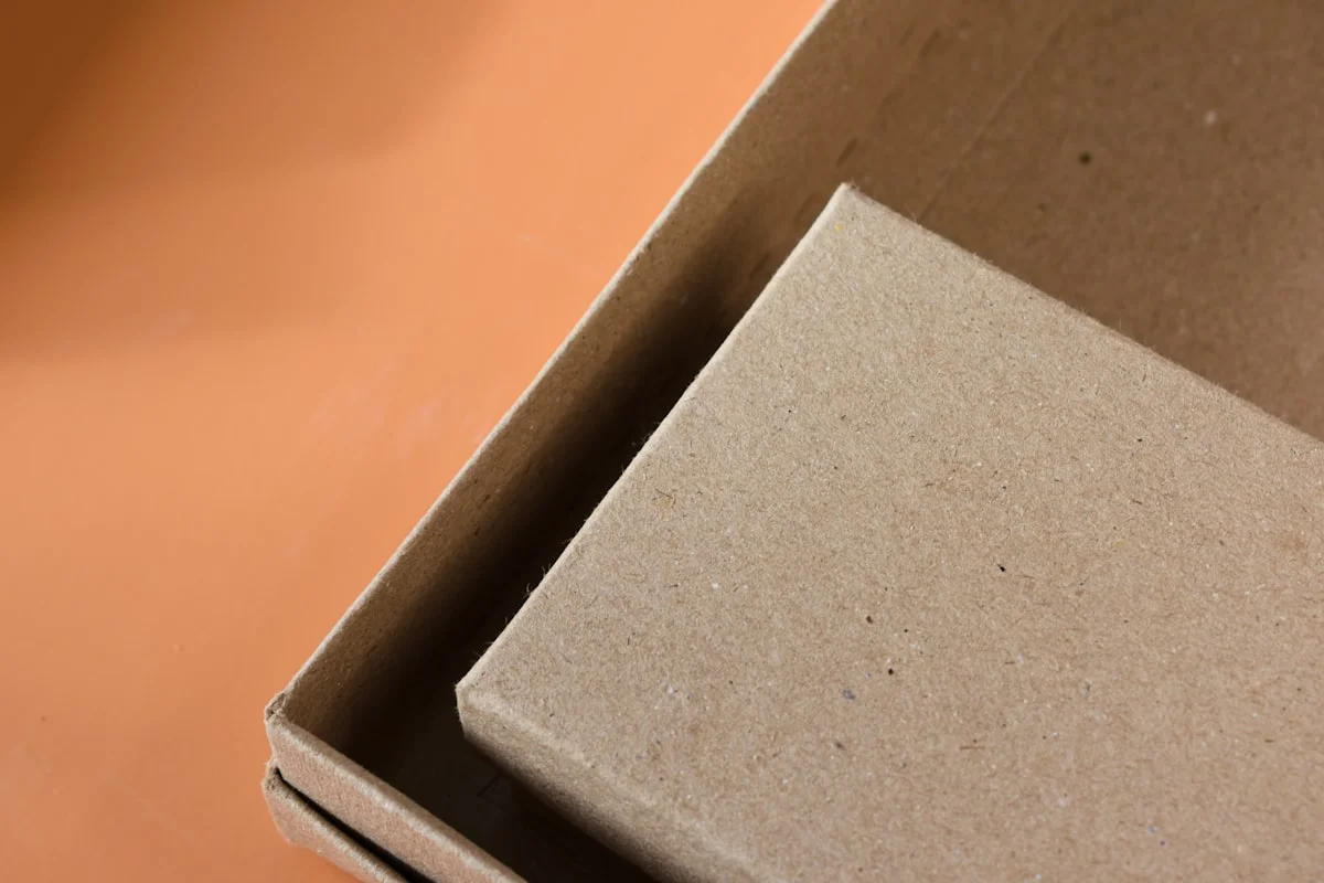 Open cardboard box showing rigid box construction with thick chipboard walls