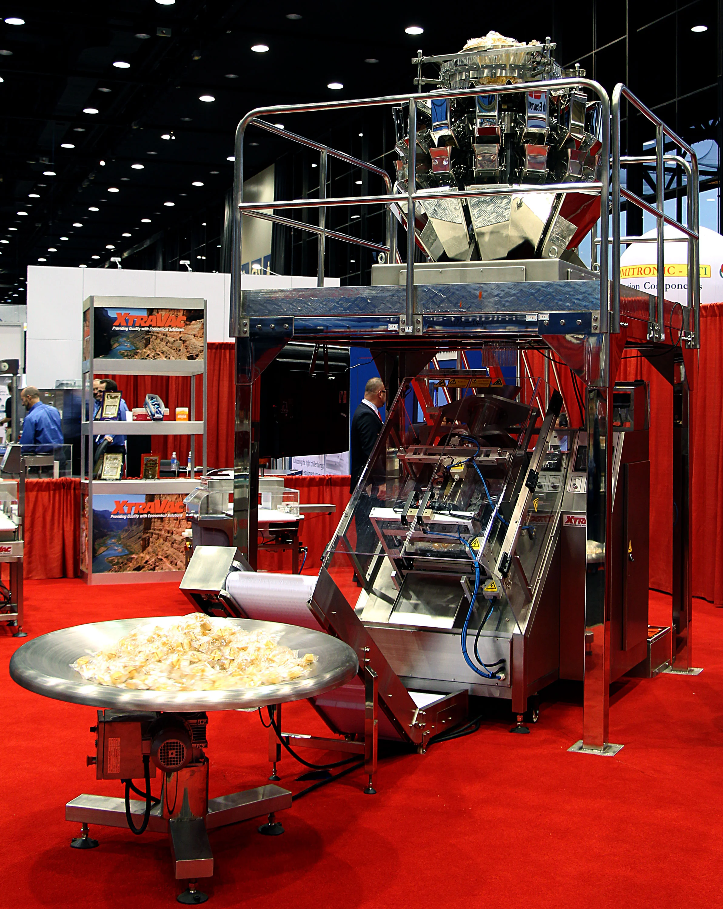 Roll-fed automated packaging machine showing filling equipment and production line compatibility