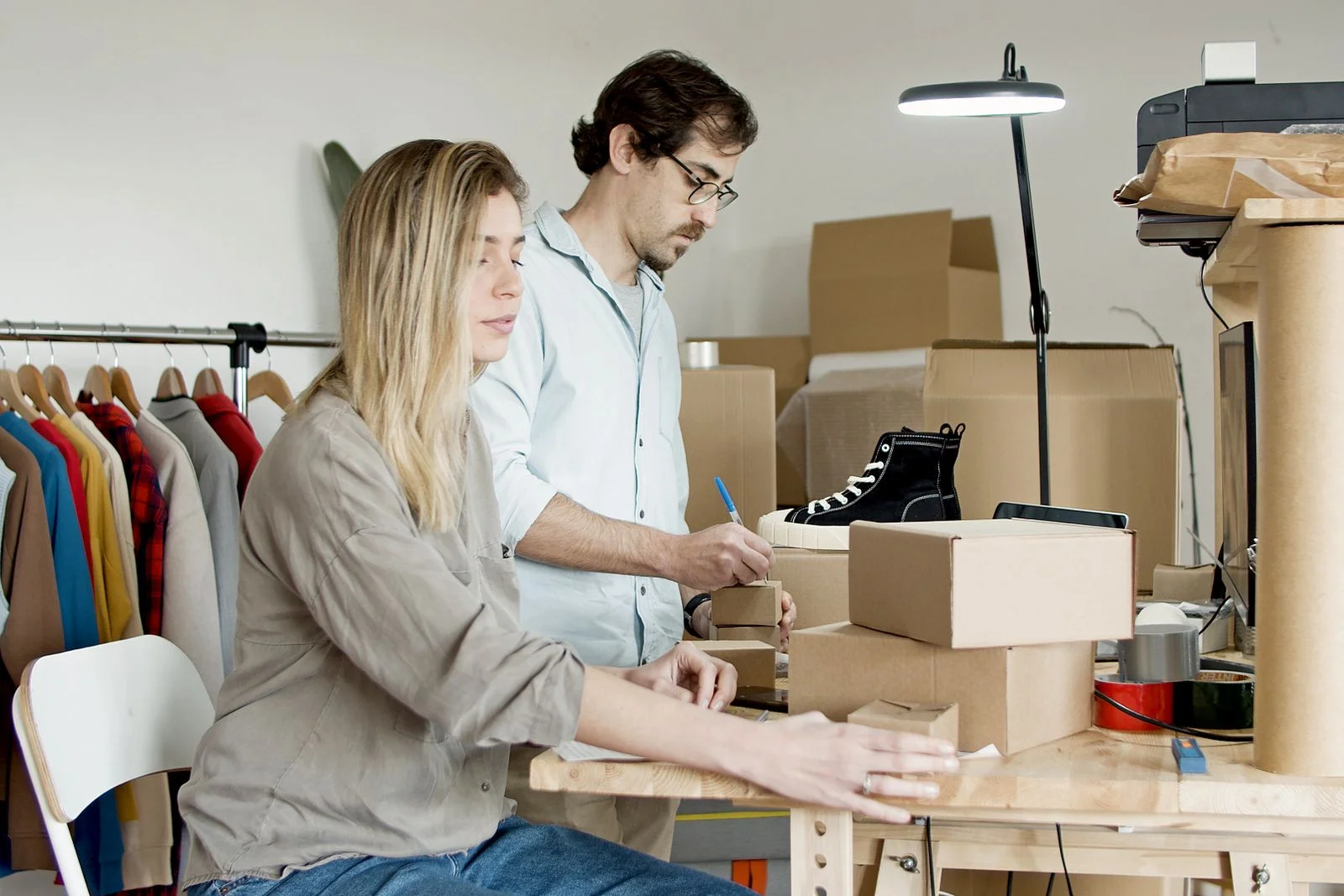 online store packaging table with boxes and products for SKU specific inserts