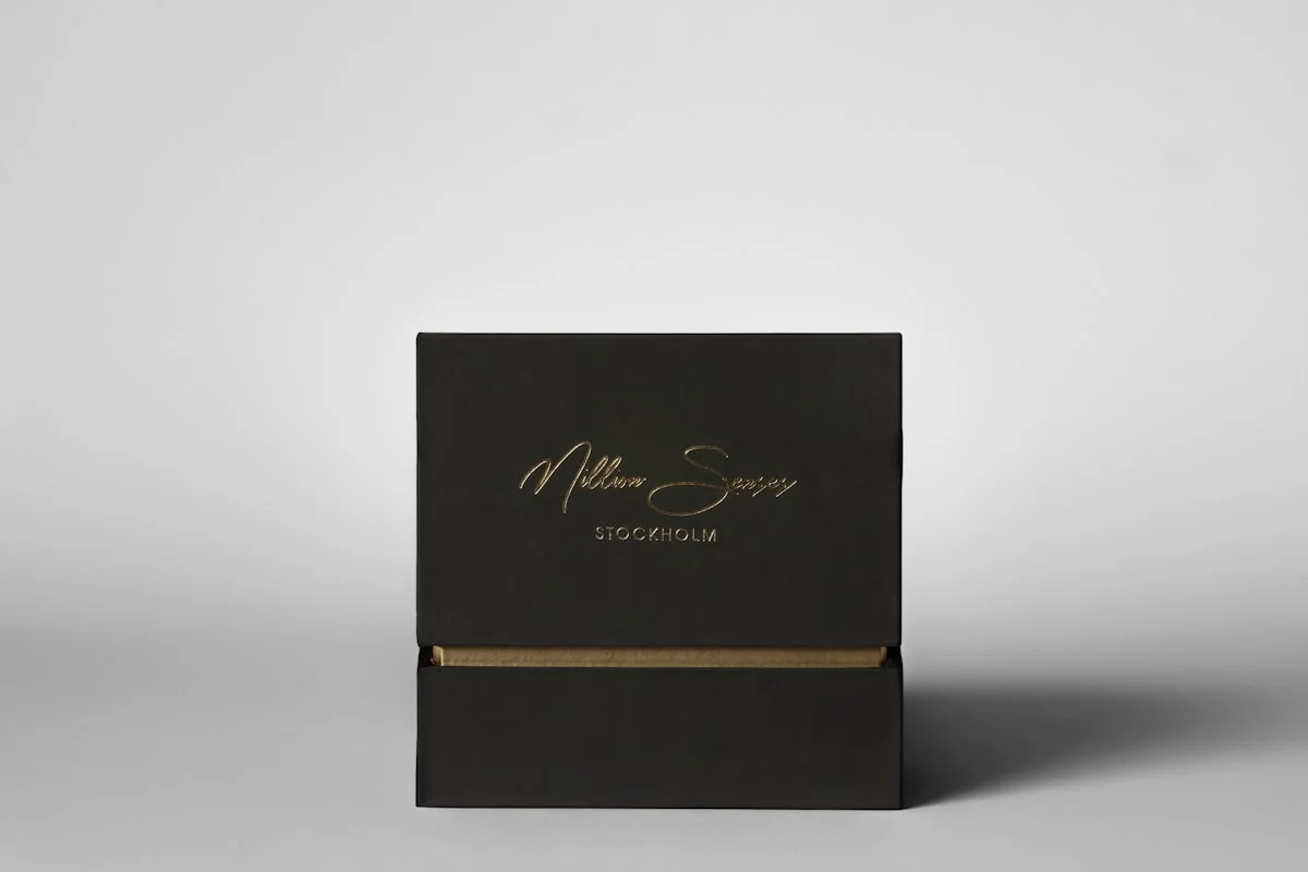 Elegant black rigid gift box with gold lettering displayed on a clean white background