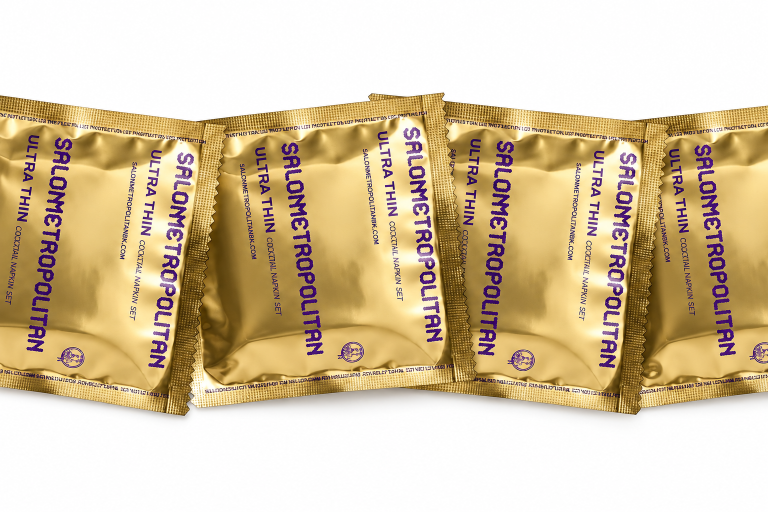 A row of gold Salon Metropolitan Ultra Thin cocktail napkin sachets is arranged on a white background.