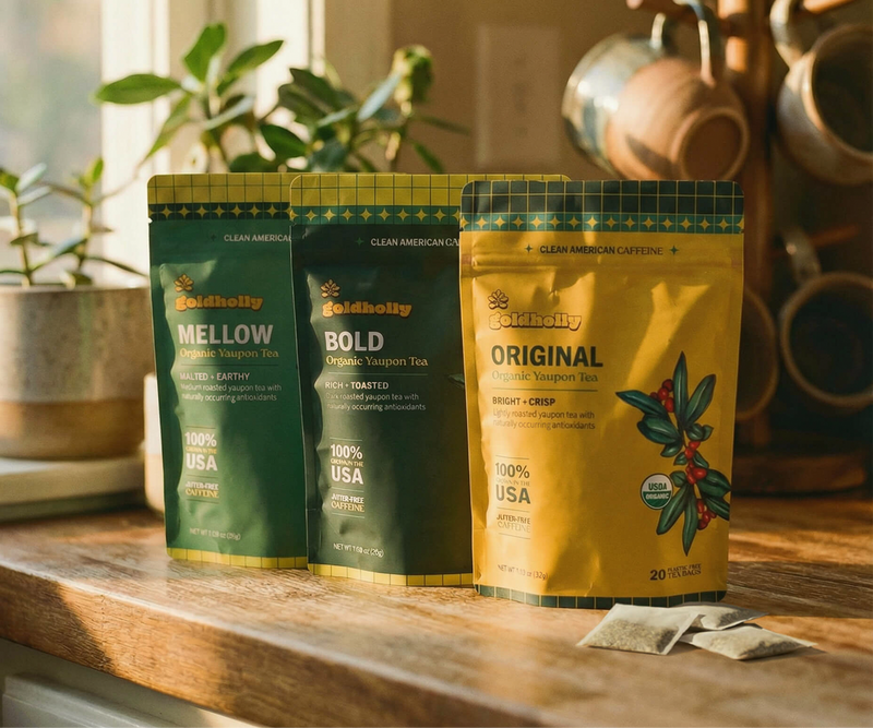 Goldholly Mellow, Bold and Original yaupon tea pouches on a wooden kitchen counter.