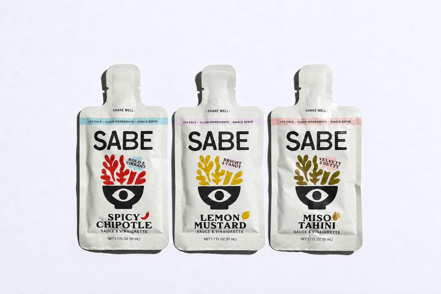 Three SABE single-serve sauce pouches in different flavors