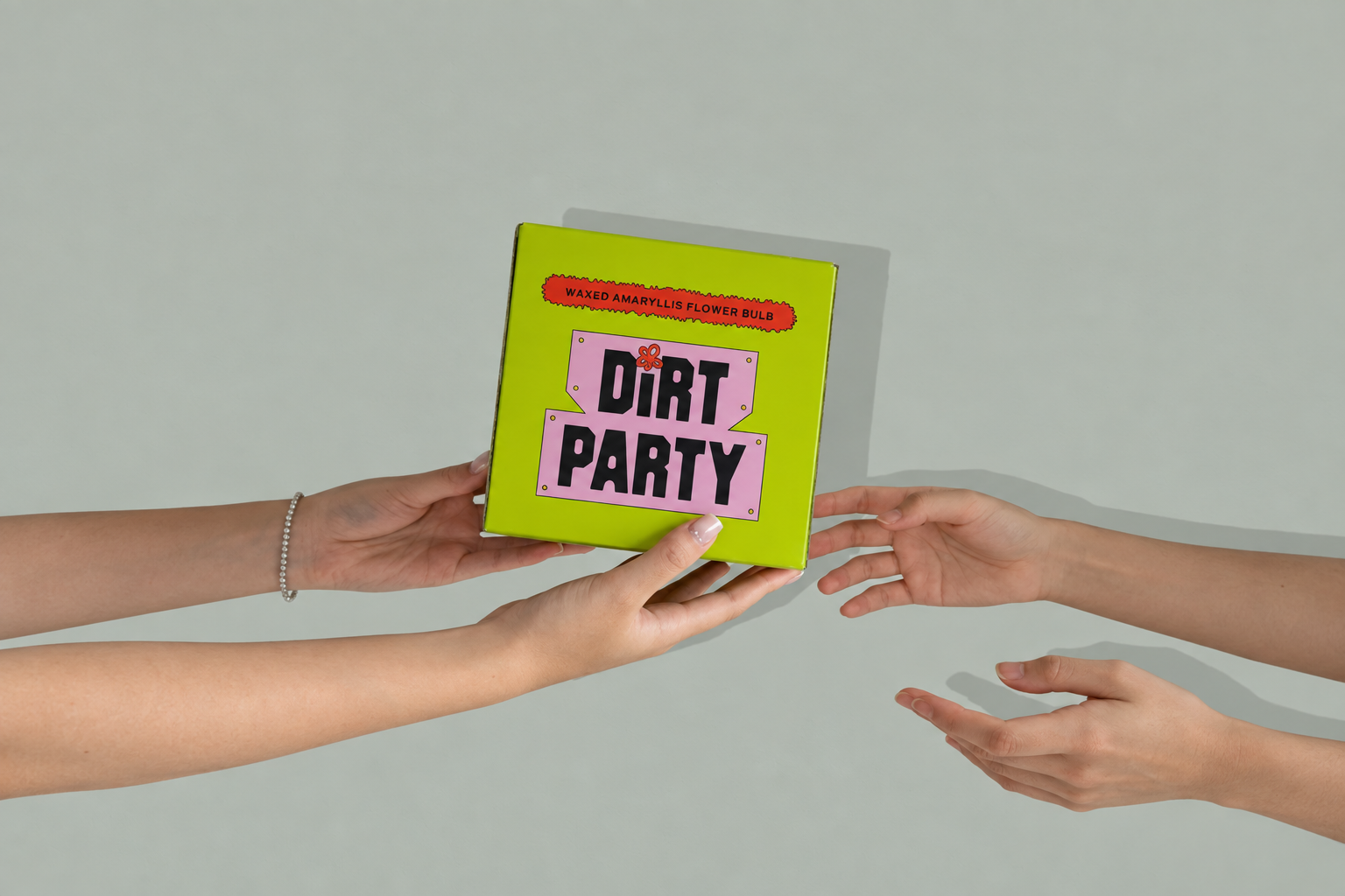 Several hands exchanging a bright green Dirt Party box