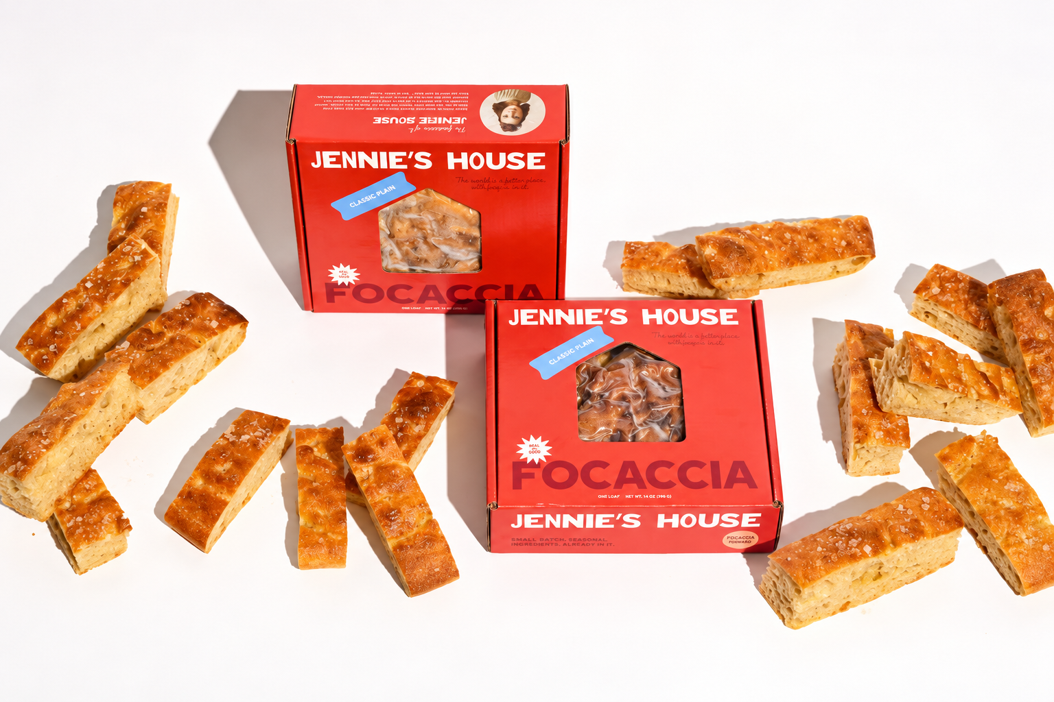 Jennie's House cartons and sliced focaccia are arranged together on a white studio surface.